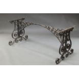 A large wrought iron table base, late 19th century,
