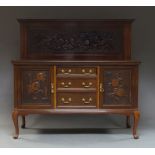 An Edwardian mahogany sideboard, with carved back ornamented with three naked cherubs with peaches,