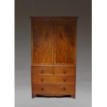 A mahogany linen press, 19th century, with two panelled doors enclosing a vacant hanging space,