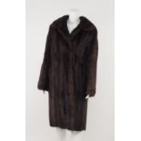 Musquash fur coat, rounded collar and full sleeves, concealed front closure and brown silk lining,