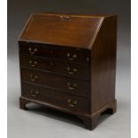 A George III mahogany bureau, mid 18th century, with fitted interior, above four long graduated