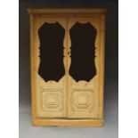 A pine display cupboard, late 19th/20th century, with two glazed and panelled doors enclosing six