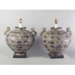 A pair of Chinese bronze lamp bases, 20th century, in the form of wine jars with kylin handles, 46cm