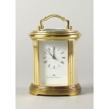 A Matthew Norman polished brass carriage clock, of recent manufacture, with an oval glazed case, the