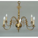 A Dutch style brass six light chandelier, with double eagle finial on bulbous column, with scrolling