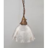 A brass and glass light fitting, early 20th century, the shade of domed petal form with holophane