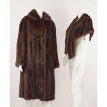 A full length mink coat, with leather covered buttons, by Cavendish House, Cheltenham, size not