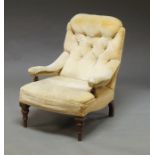 A Victorian button back armchair, upholstered in cream velvet, on turned legs
