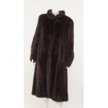 A dark mink full length fur coat, round collar with single large horn style toggle at neck,