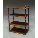 A Victorian mahogany four tier whatnot, on turned pilaster supports, (lacking feet), 95cm high x