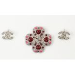 Chanel: a silvered metal and faux stone brooch, Autumn 2012 collection, of four leaf clover form,