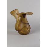 A studio glass pitcher plant form vase, late 20th century, the tonal amber glass conforming in a