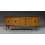 A walnut sideboard by Stonehill Furniture, circa 1950-1960, with folding cupboard door enclosing a