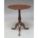 A George III style mahogany tilt top table, late 19th century, the top with pie crust edge, on