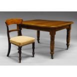 An oak extending dining table, early 20th century, on turned legs, with ceramic castors, with two