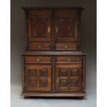 A French provincial cupboard on stand, the upper tier with double panelled doors, with drawers below