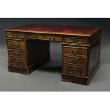 A rectangular mahogany pedestal desk, late 20th century, the top inset with red leather writing