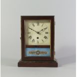 An American faux rosewood rectangular shelf clock, late 19th century, with door enclosing clear