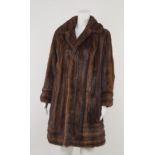 A double breasted mink coat, with rounded collar and lapels, size not stated.