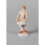 A Continental porcelain figure of a man, 18th century, wearing a floral tunic and purple breeches,