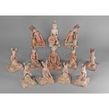 A collection of twelve Chinese pottery Tang style figures of kneeling musicians,