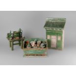 A collection of Chinese green glazed pottery, Ming dynasty, comprising a miniature altar table,