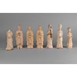 Seven Chinese pottery straw glazed attendant figures, Sui/Tang dynasty, each modelled standing,