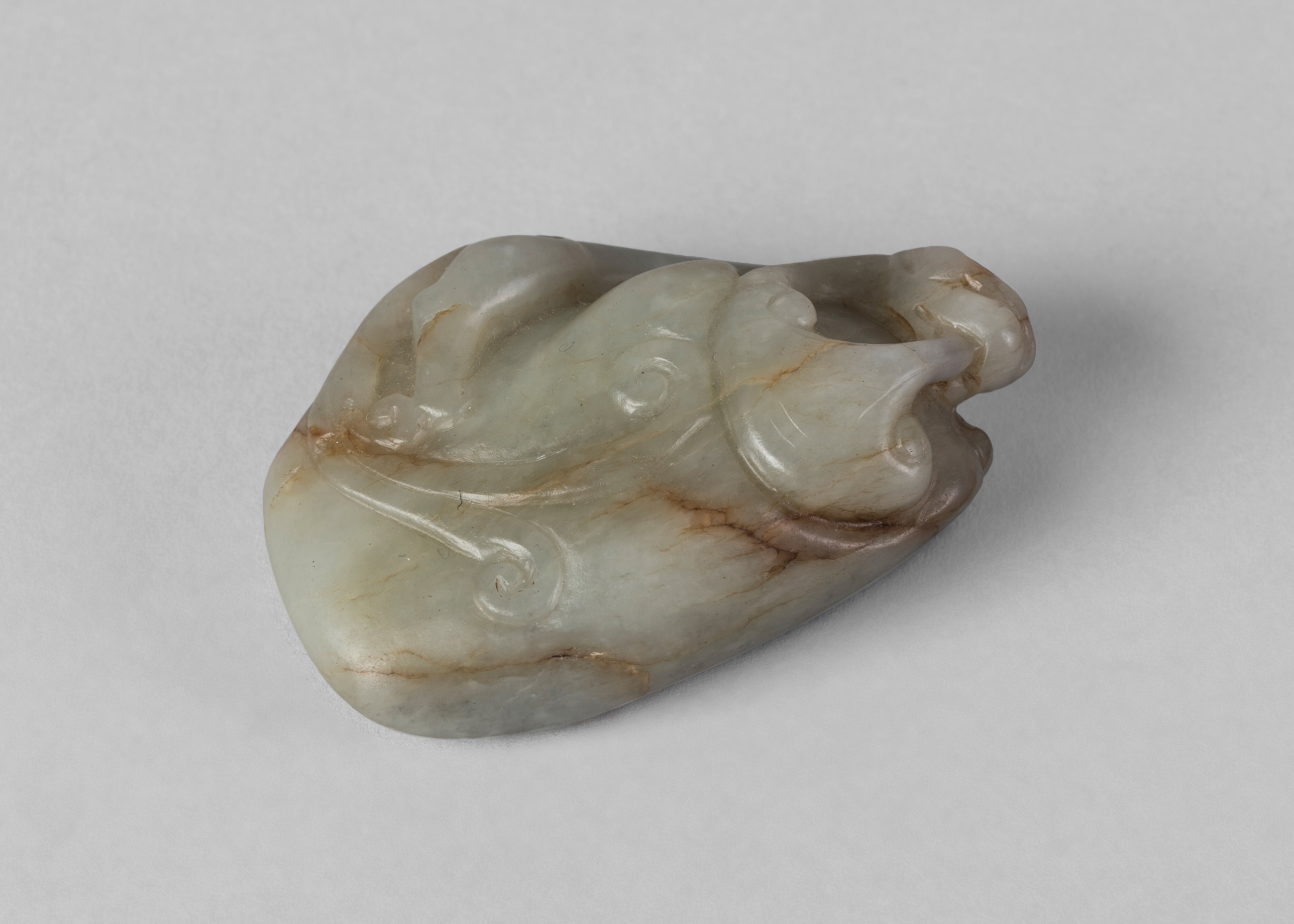 A Chinese pale green jade pebble pendant, late Qing dynasty,