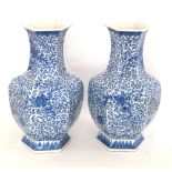 A pair of Chinese hexagonal form porcelain vases, of recent manufacture, printed overall with