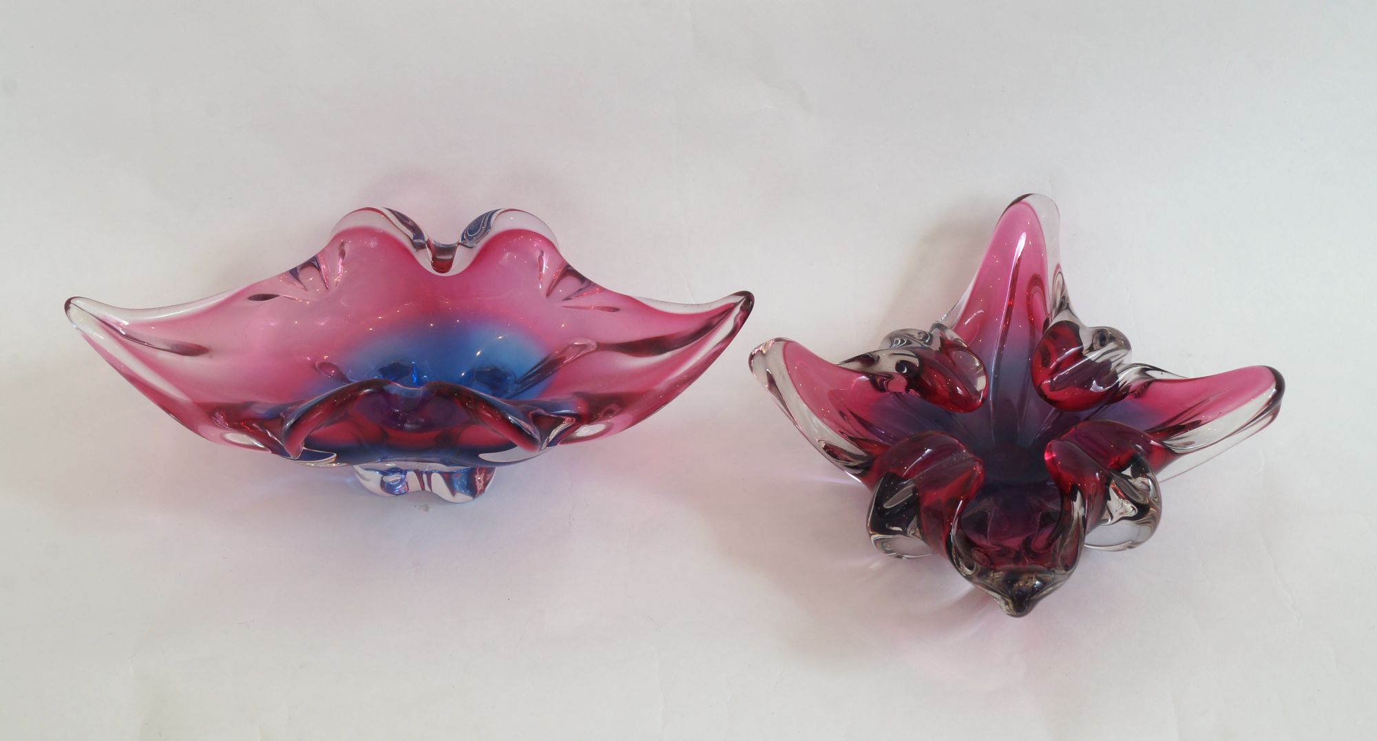 A footed ovoid glass bowl, late 20th/early 21st century, blue and magenta cased in clear, width