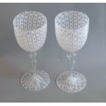 Salviati, Murano, two wine glasses with latticino decoration in white, e.a. height 23cm; accompanied