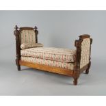 A French walnut dolls bed, late 19th century, with padded ends framed by fluted columns,