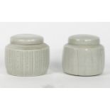 David Leach, British, 1911-2005, a pair of lidded pots with pale Celadon glaze, one with incised