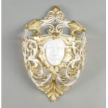 A Victorian porcelain pierced wall pocket, moulded with a female mask , overall with scrolling