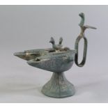 An Indian patinated bronze model of an oil lamp, late 19th/20th century,