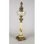 An oil lamp, late 19th/early 20th century, with an onyx column, on a stepped leaf moulded base,