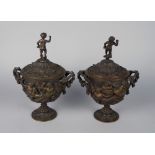 A pair of French bronze twin handled vases and covers, 19th century, each , with a putto finial,
