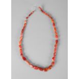 A Western Asiatic necklace of graduated carnelian and agate faceted beads, circa 1000 BC, 47cm.