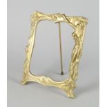 An Art Nouveau style brass framed mirror, moulded with a female figure and trailing branches,