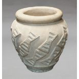 A large modern pink stone vase, decorated with bands of geometric turning,