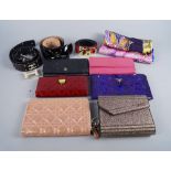 A collection of purses, scarves and belts,