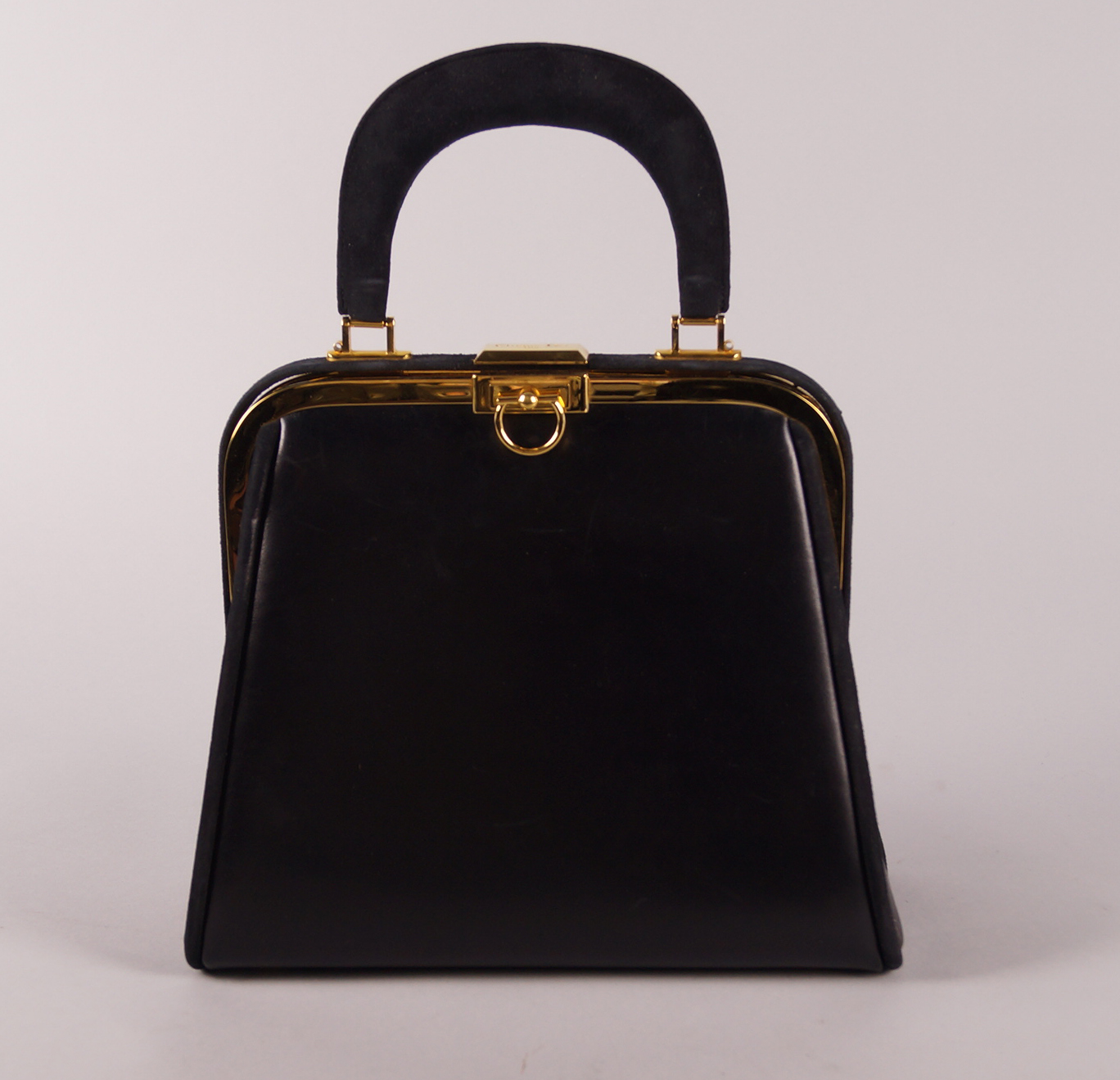 A Christian Dior black leather and suede handbag, single rigid handle and gold plated hardware,