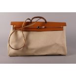 A large Hermes 'Her' bag and cover, canvas and tan leather, 52cm wide,