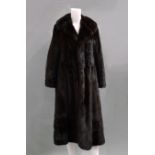 A dark brown full length ranch mink coat by Calman Links, double breasted with silk covered buttons,