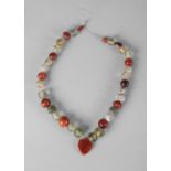 A Roman greenish glass, carnelian and agate bead necklace, circa 1st-3rd Century AD,