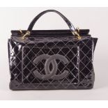 A Chanel large black patent handbag, two external pockets with black leather CC logo to one,