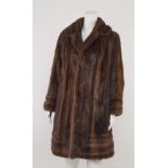 A double breasted mink coat, with rounded collar and lapels, size not stated.