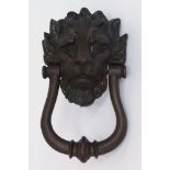 A bronze brass door knocker, 20th century, in the form of a lion with a U-form hammer,