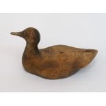 In the manner of Guy Taplin, a carved wood duck decoy,