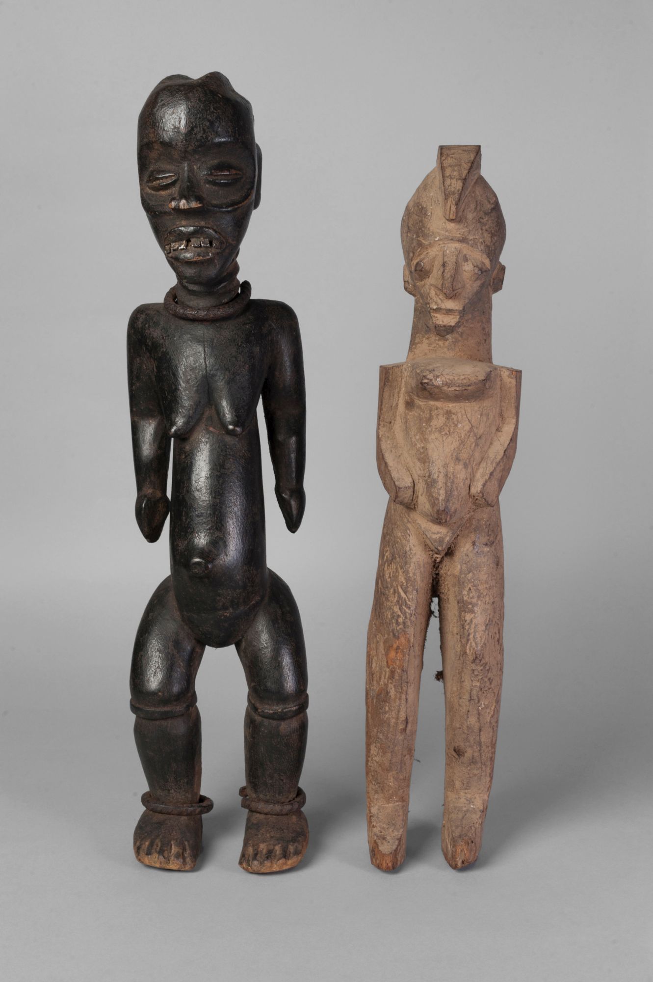 A tribal hardwood figure of a woman, Ivory Coast, Baule,